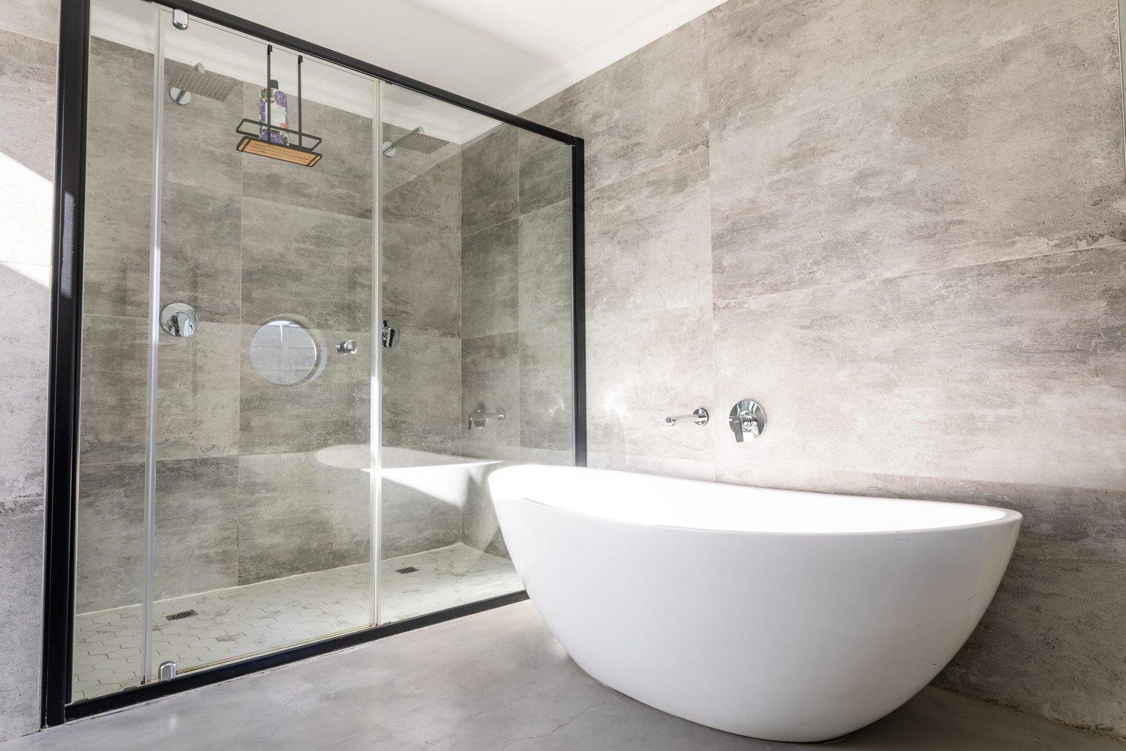 Empty bathtub by modern shower in bathroom at home. unaltered, home and interior decoration concept.